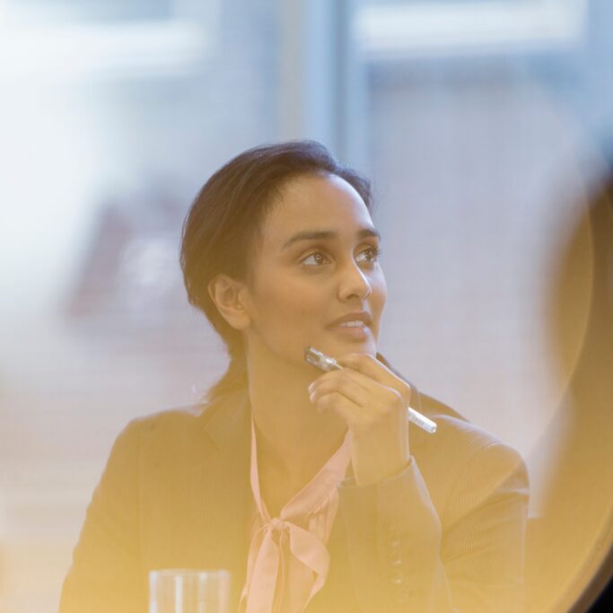 Attentive young businesswoman listening in meeting